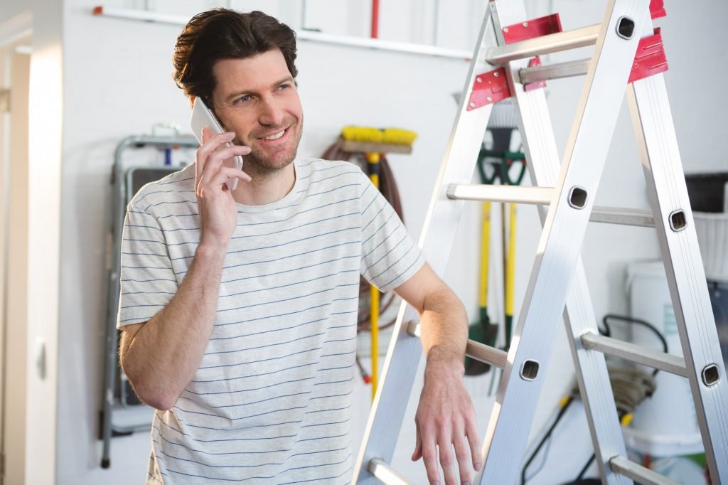 Male painter talking on mobile phone in workshop